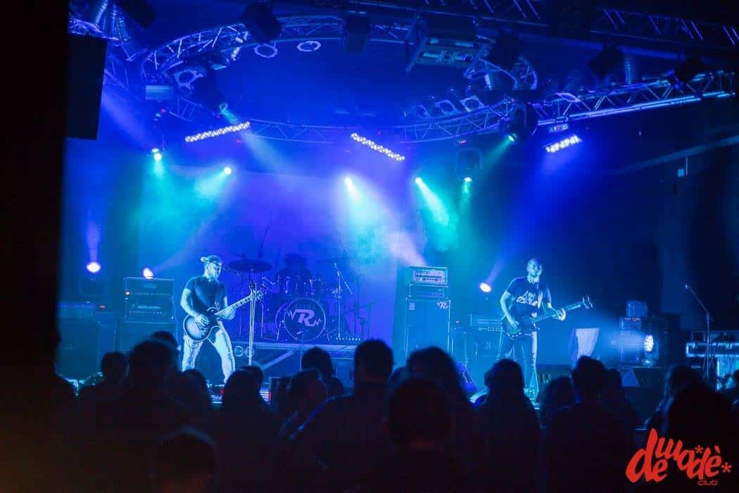 A group of people on stage at a concert.