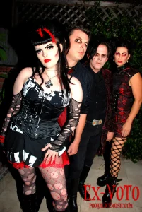 A group of people in gothic outfits posing for a photo.