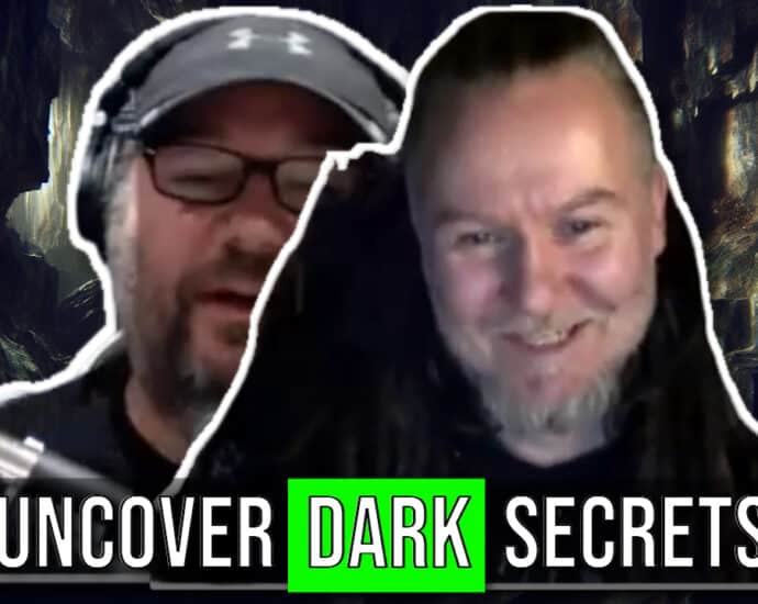 Two men smiling in front of a dark background with the text "Uncover Dark Secrets" displayed at the bottom, reminiscent of a Lost Interview with Mortiis.